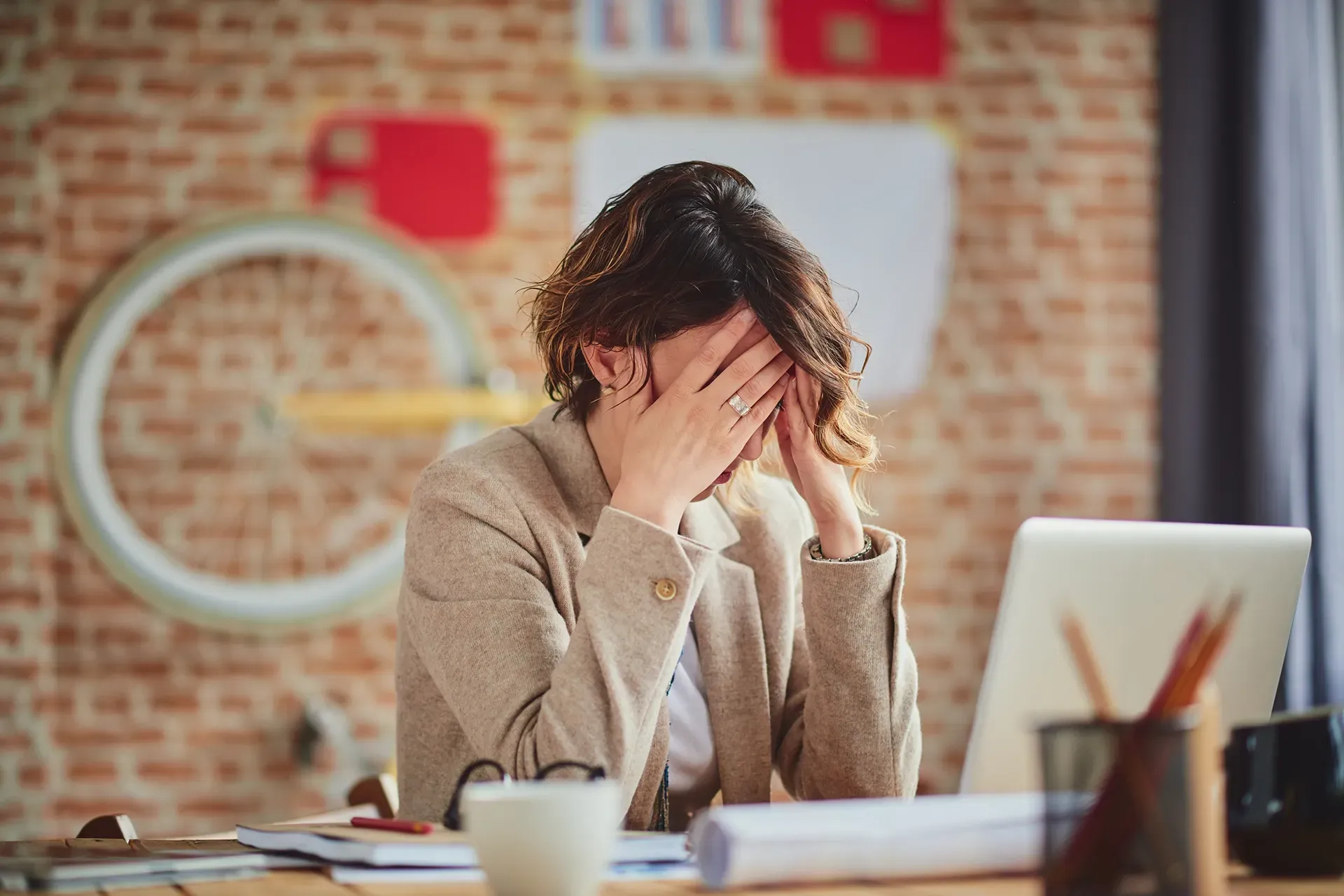 Suspicious Overcontroller woman working at desk