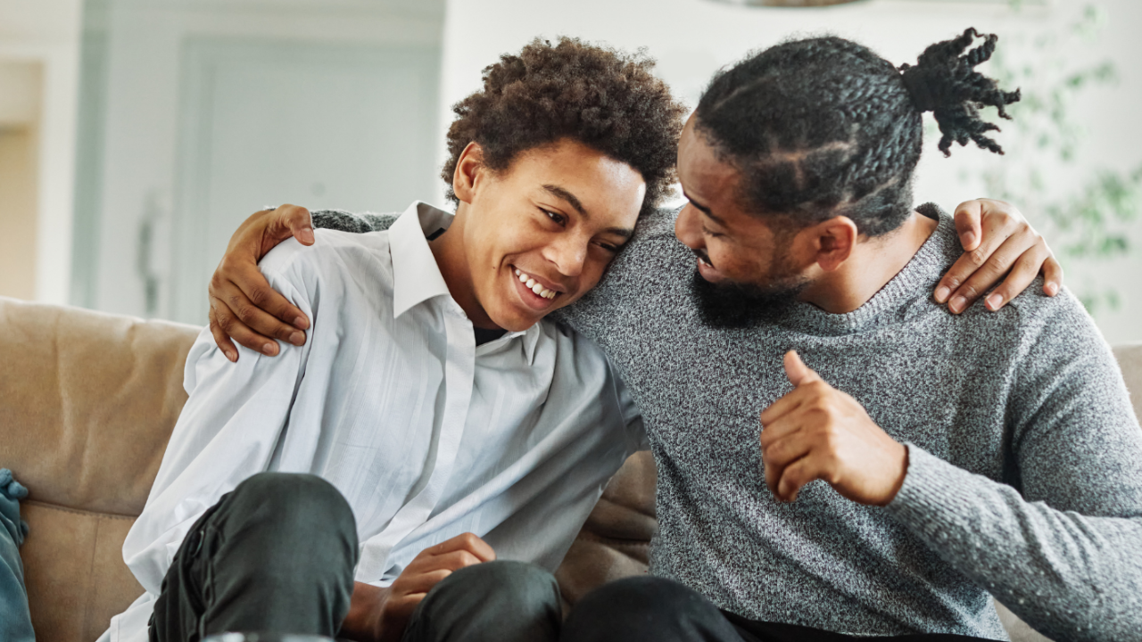 Parent calmly talking with teen during a quiet moment—representing connection built through self-regulation and trust.