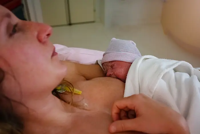 Mother and new newborn baby breastfeeding during the first 72 hours