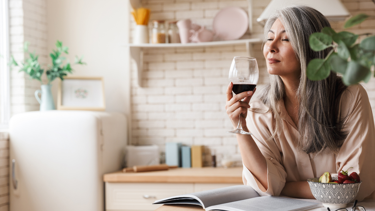 woman drinking wine visualizing her ideal home