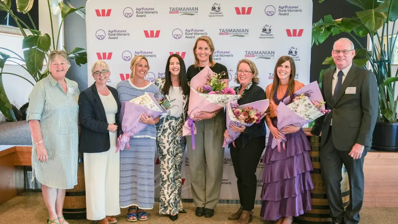 Group photo of 2025 Tasmanian AgriFture Awards including Filly holding a bouquet of flowers