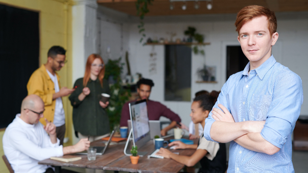 Male manager stands in front of a team experiencing team engagement