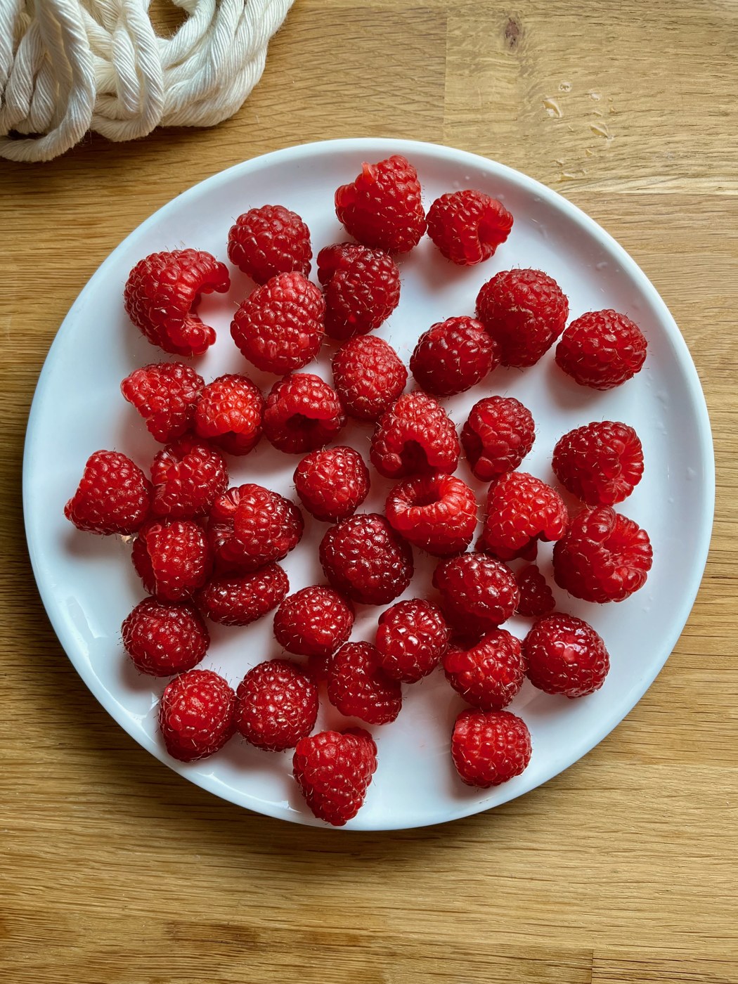 Fresh raspberries on a white plate