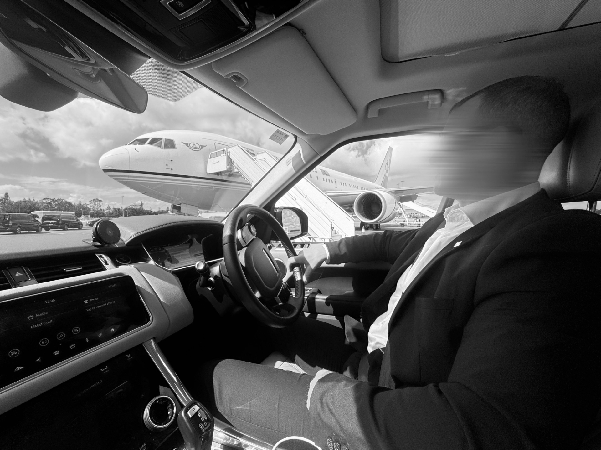 Executive security team managing multi-leg executive travel with private aircraft and secure transport for AUKUS company leadership