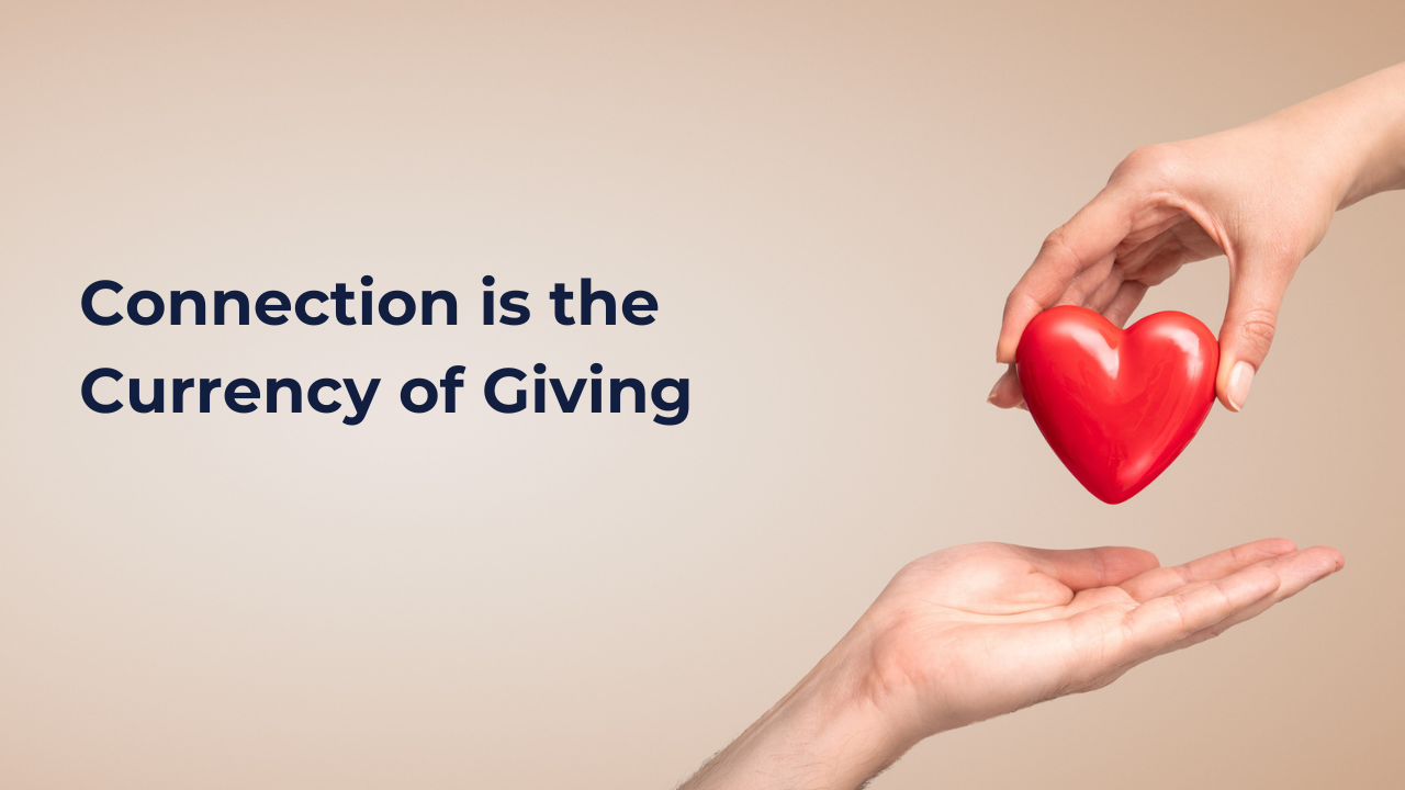 one hand placing a heart into another hand