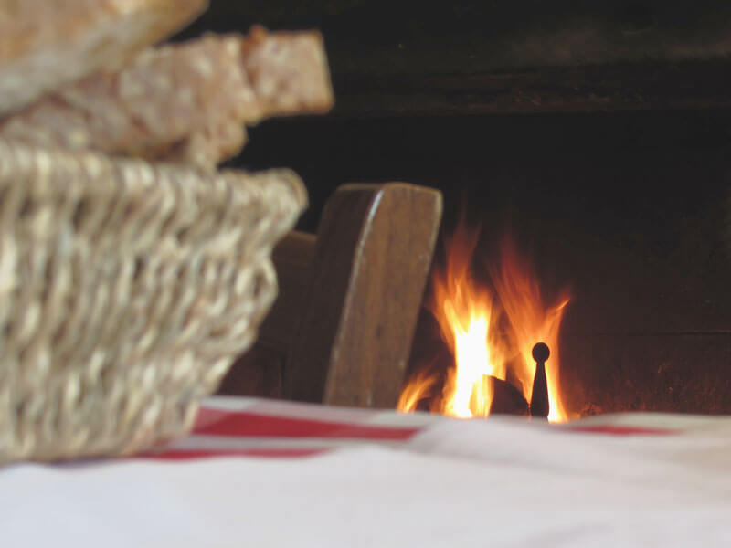  basket of bread in front of a fireplace