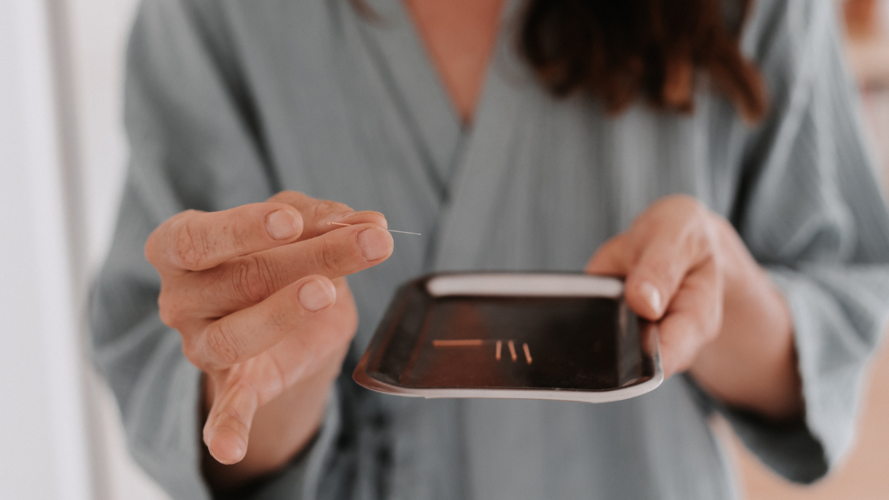Angela Chambers, acupuncturist, holding acupuncture needles