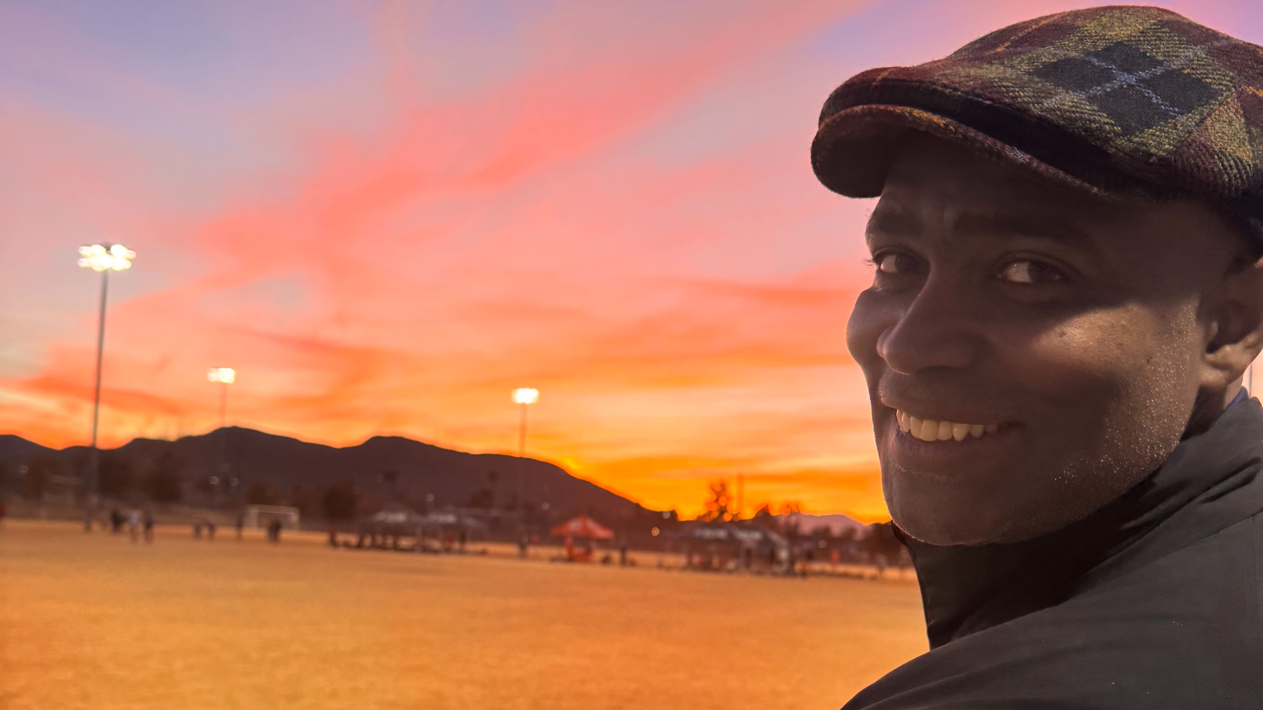 Ivan at a frozen soccer pitch. The background is a colourful sunset.