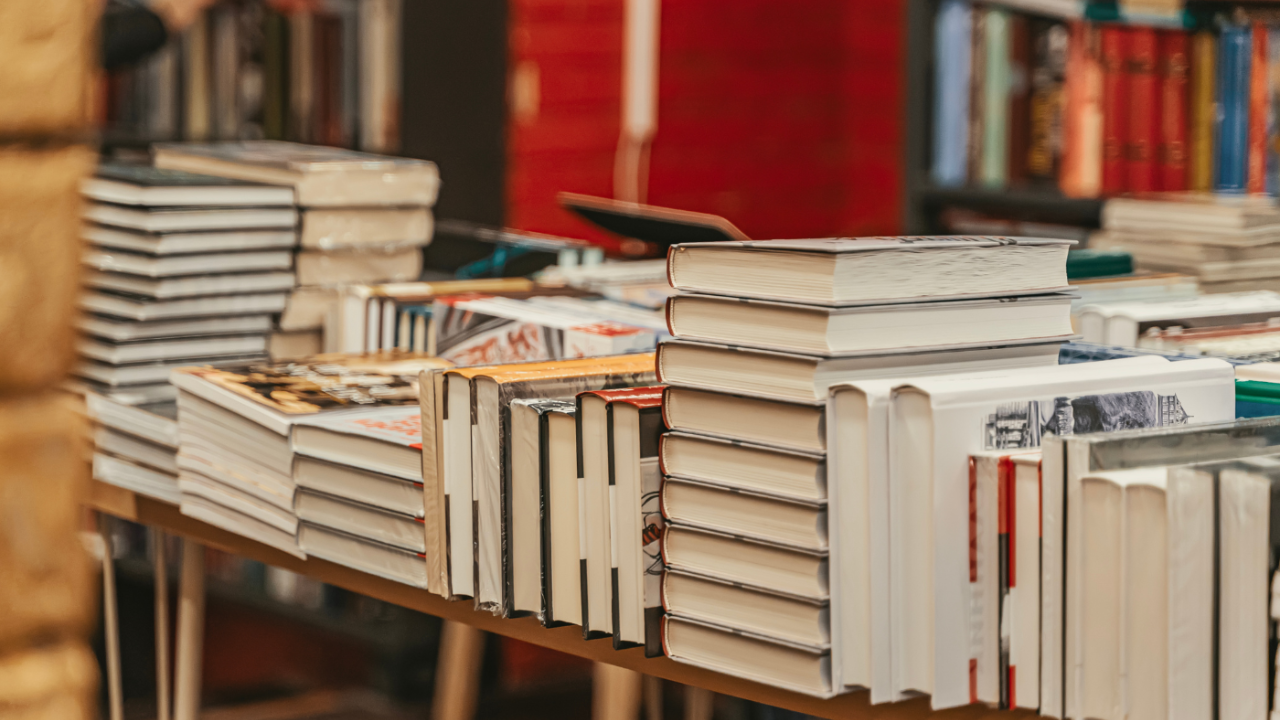 books piled on a table for sale
