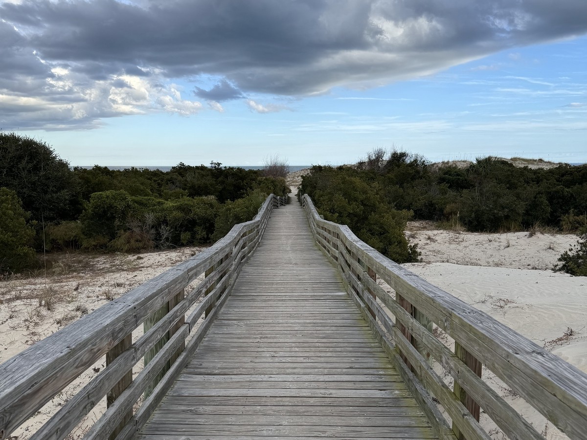 Wooden boardwalk through sand dunes to the beach on Cumberland Island