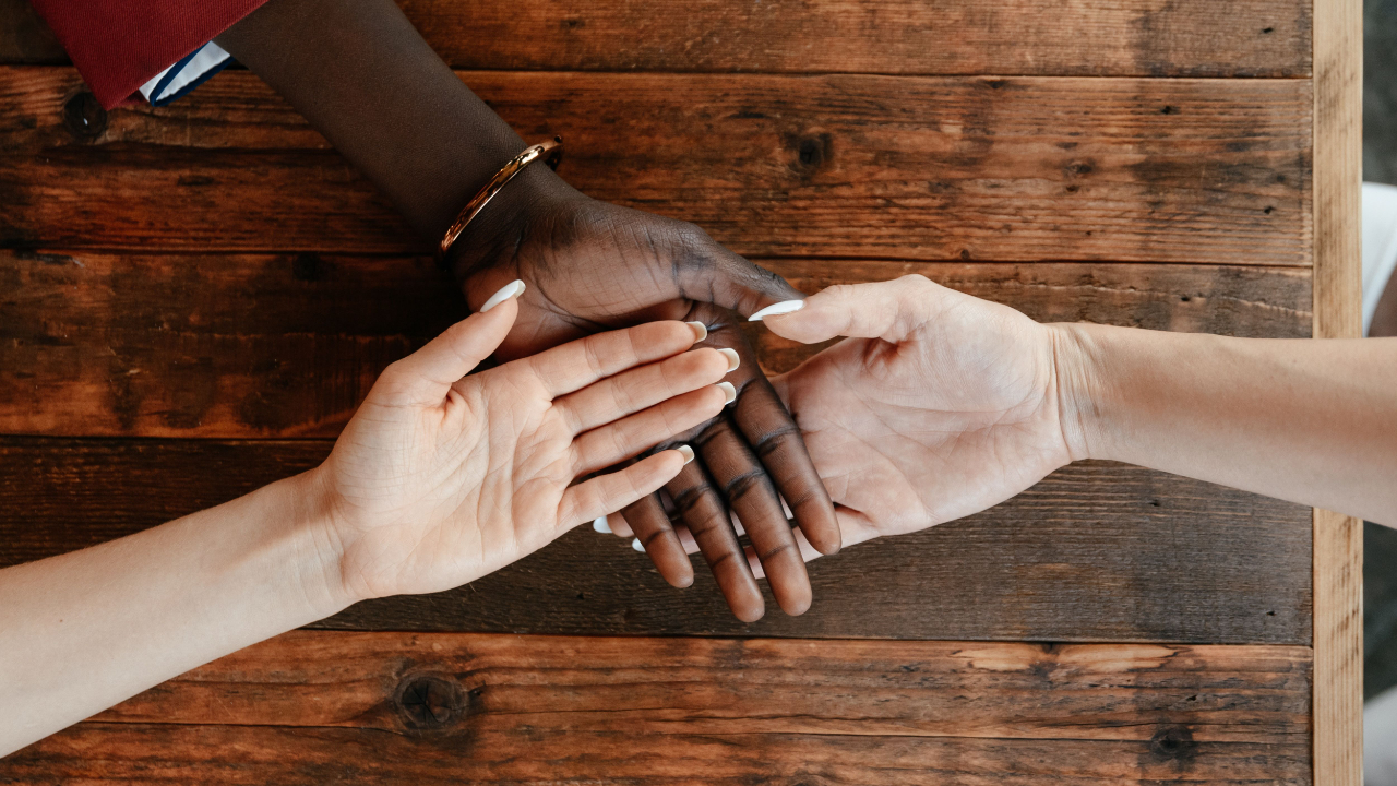 Image of 3 hands on top of each other