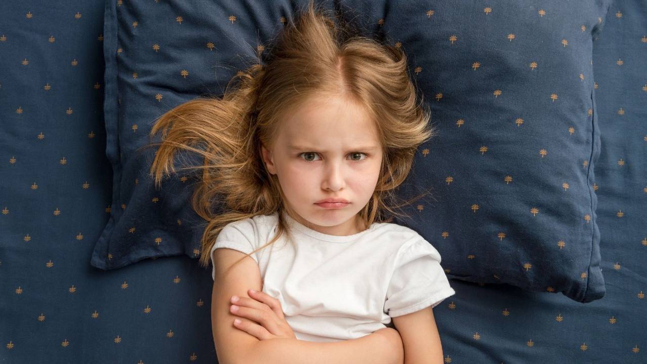 Strong-willed child resisting bedtime