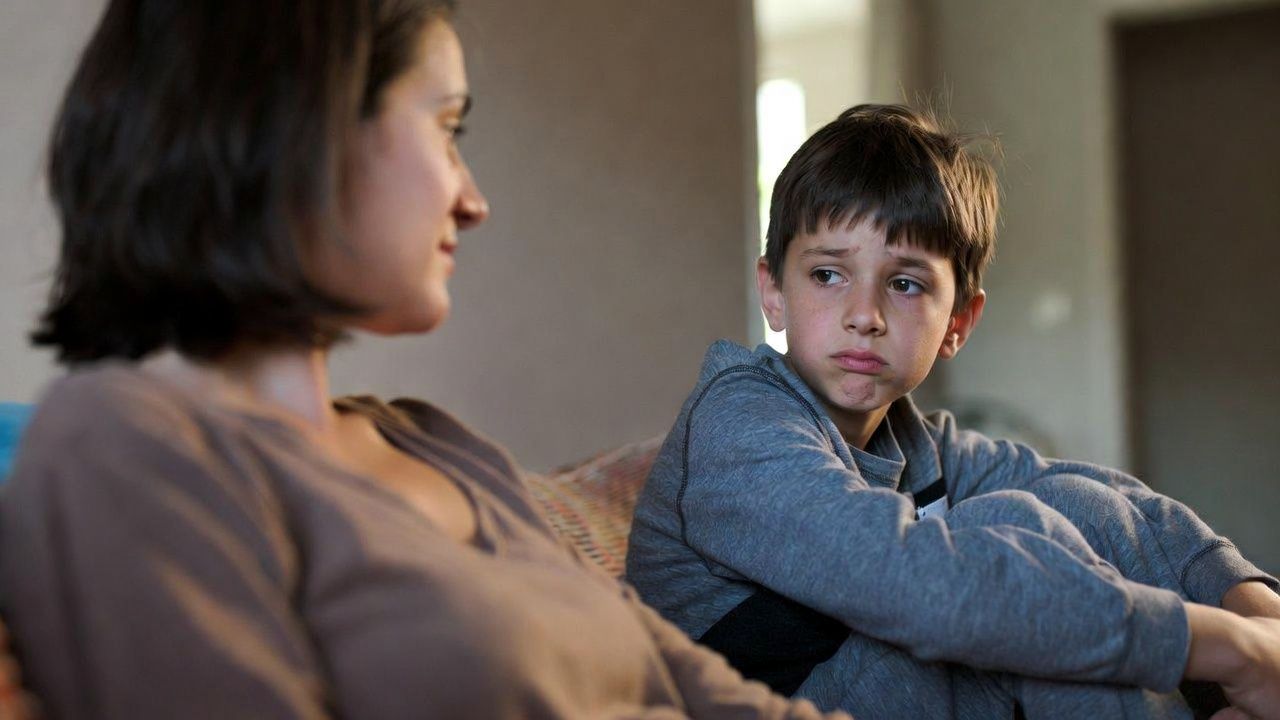 Parent pausing to listen to a frustrated child, supporting emotional safety and self-esteem