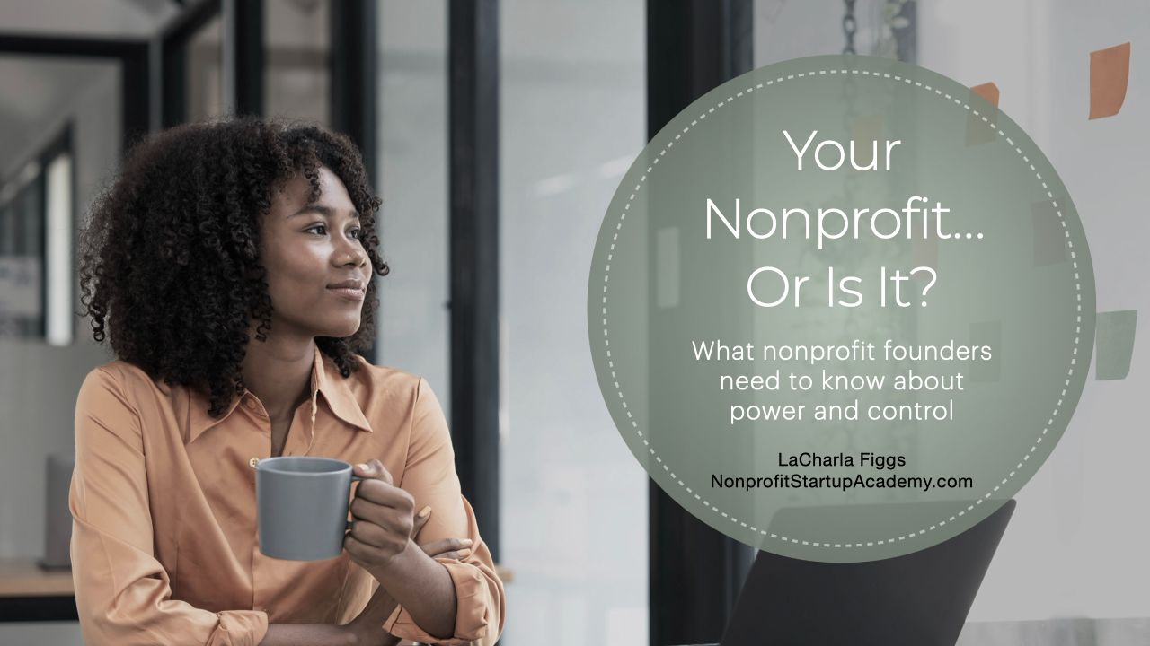 Young woman at a desk holding a coffee cup and looking thoughtfully out the window 