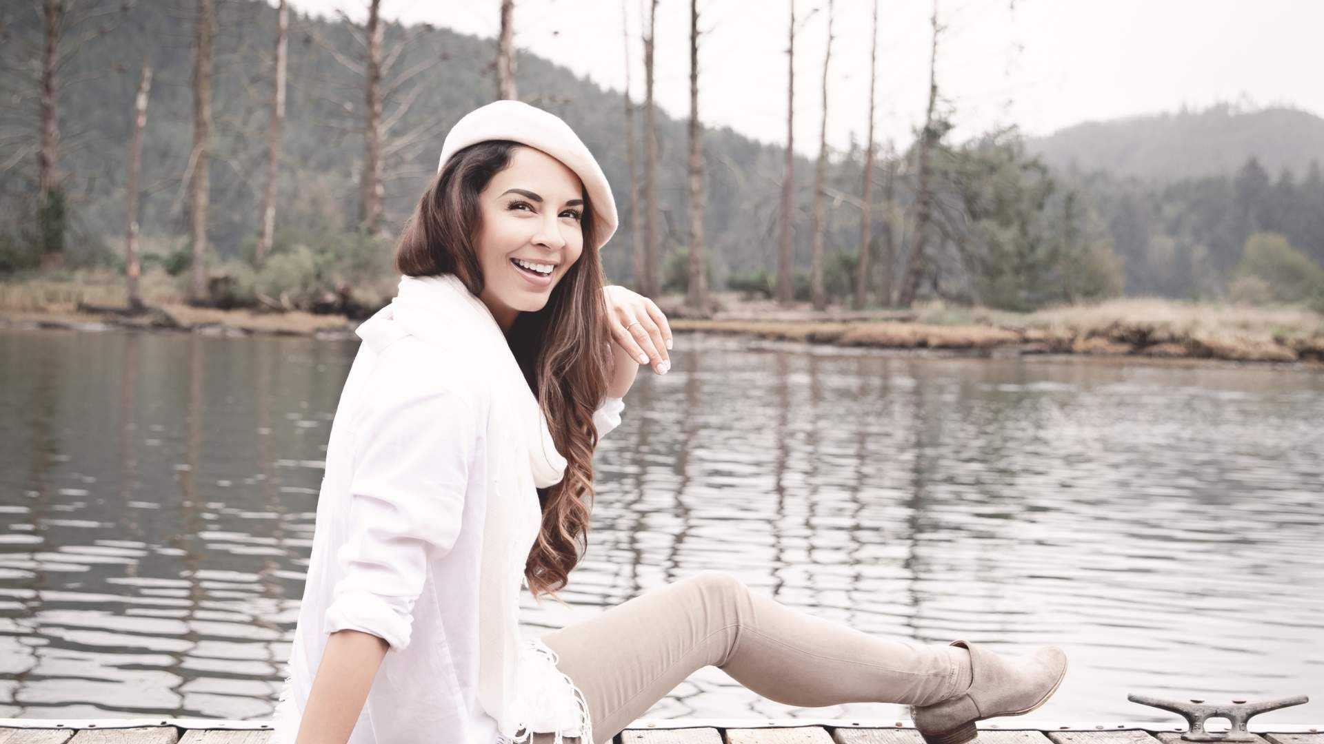 Sandy Grigsby sitting on dock, smiling