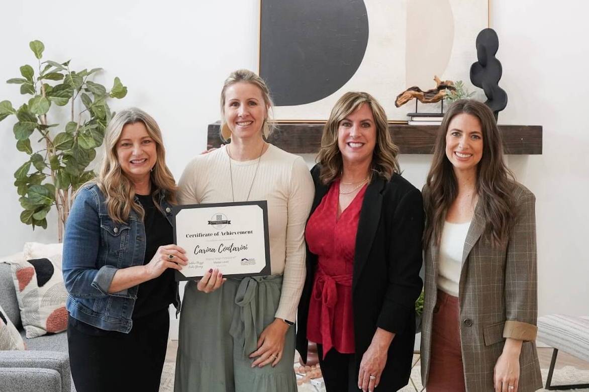 Staging Studio coaches Debbie Boggs, Julie Young, and Andress Eichstadt present Carina Contarini with a Certificate of Achievement for becoming a Master Stager