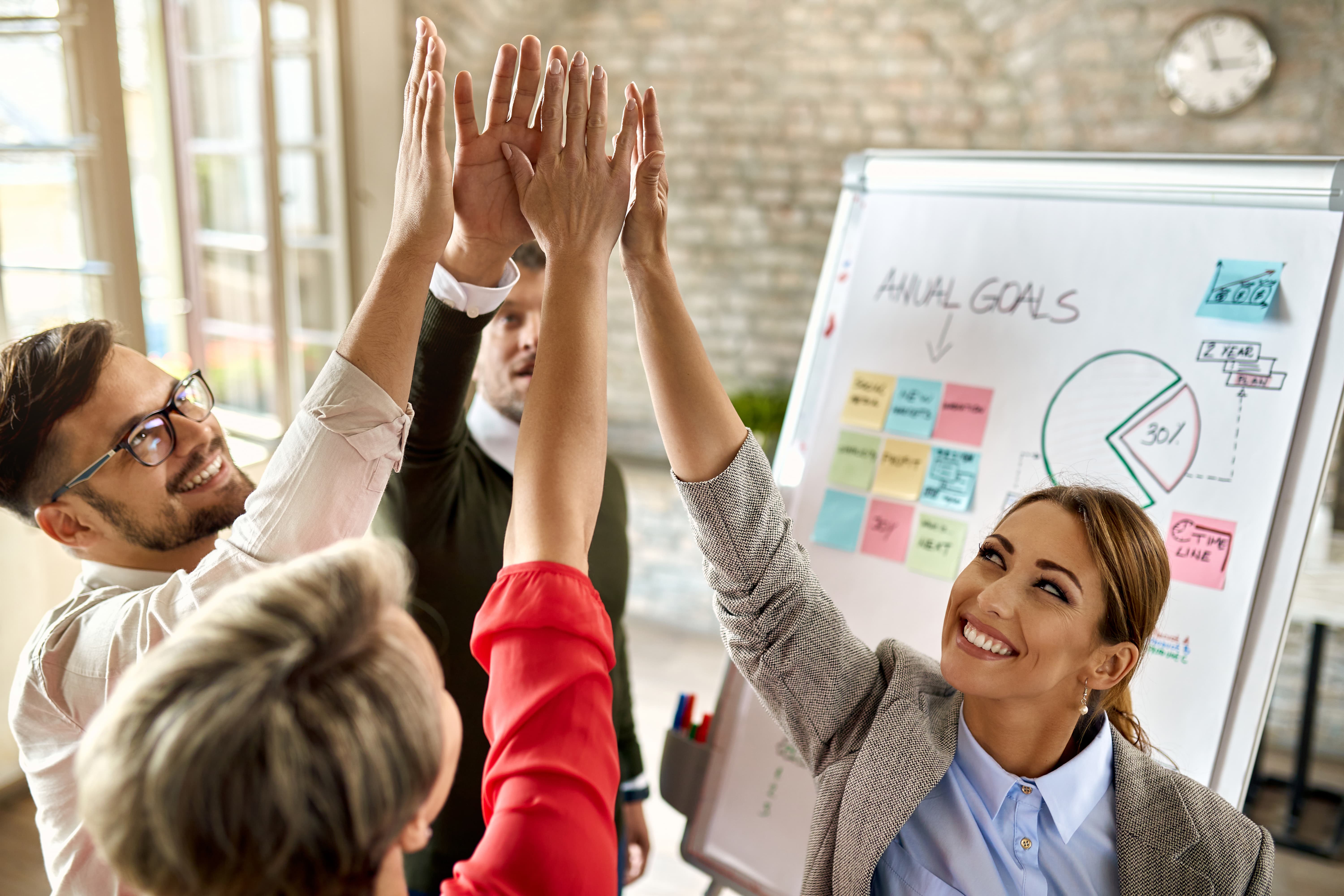   Team celebrating goals in a strategy workshop with Dreem Coaching & Consulting