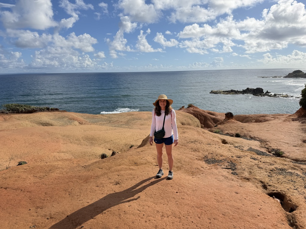 Mindy Gulas standing on a coastal trail during an active trip