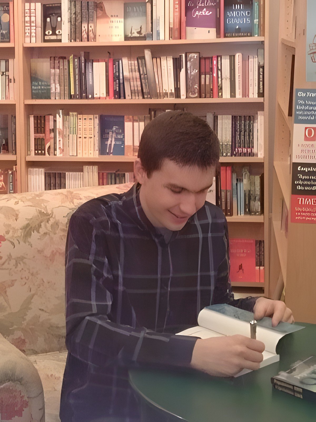 Tyler McNamer signing copies of Population ONE at a bookstore