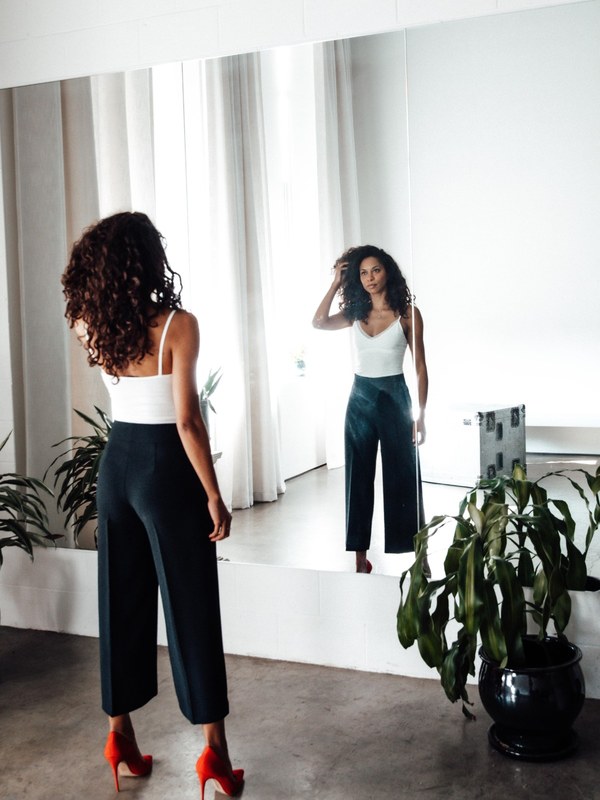 Leah Brathwaite looking at herself in the mirror