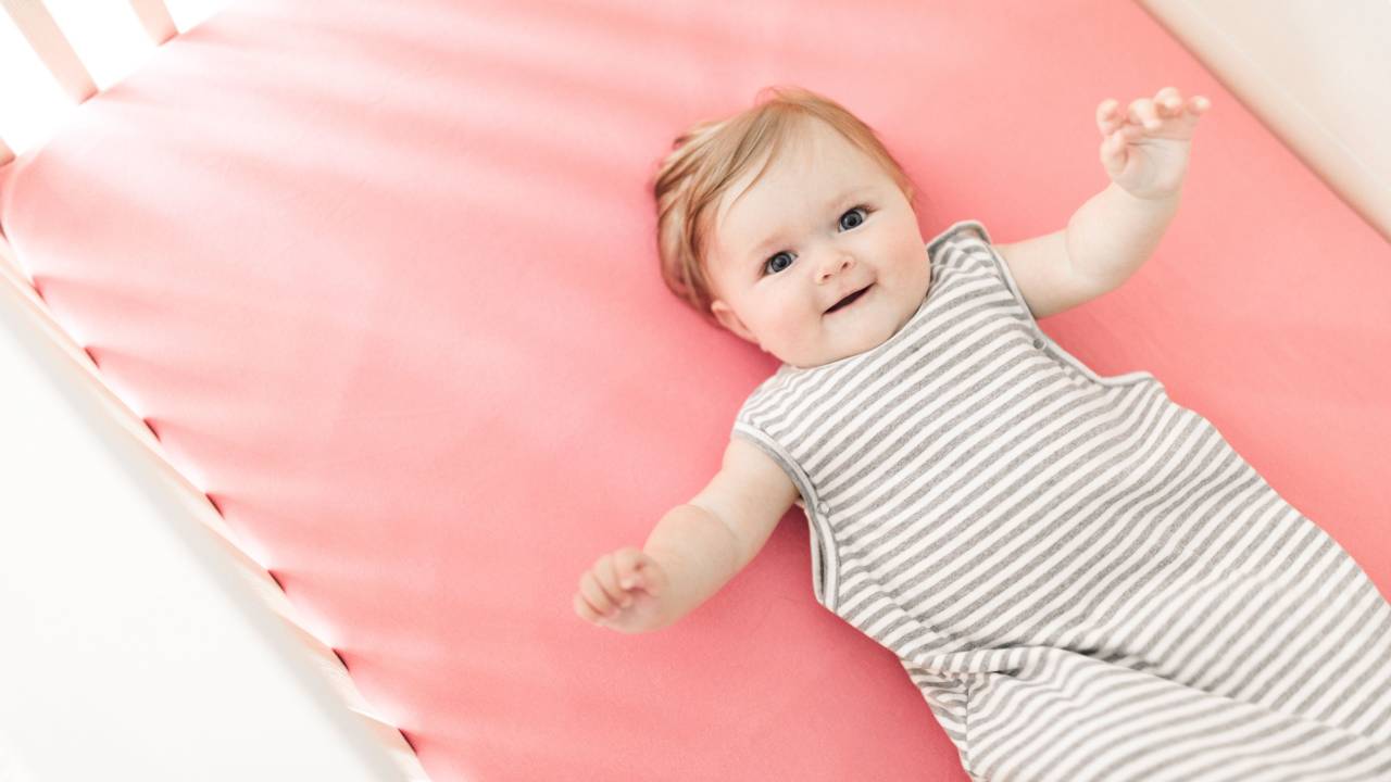 A baby awake in their crib shortly after being put down for the night