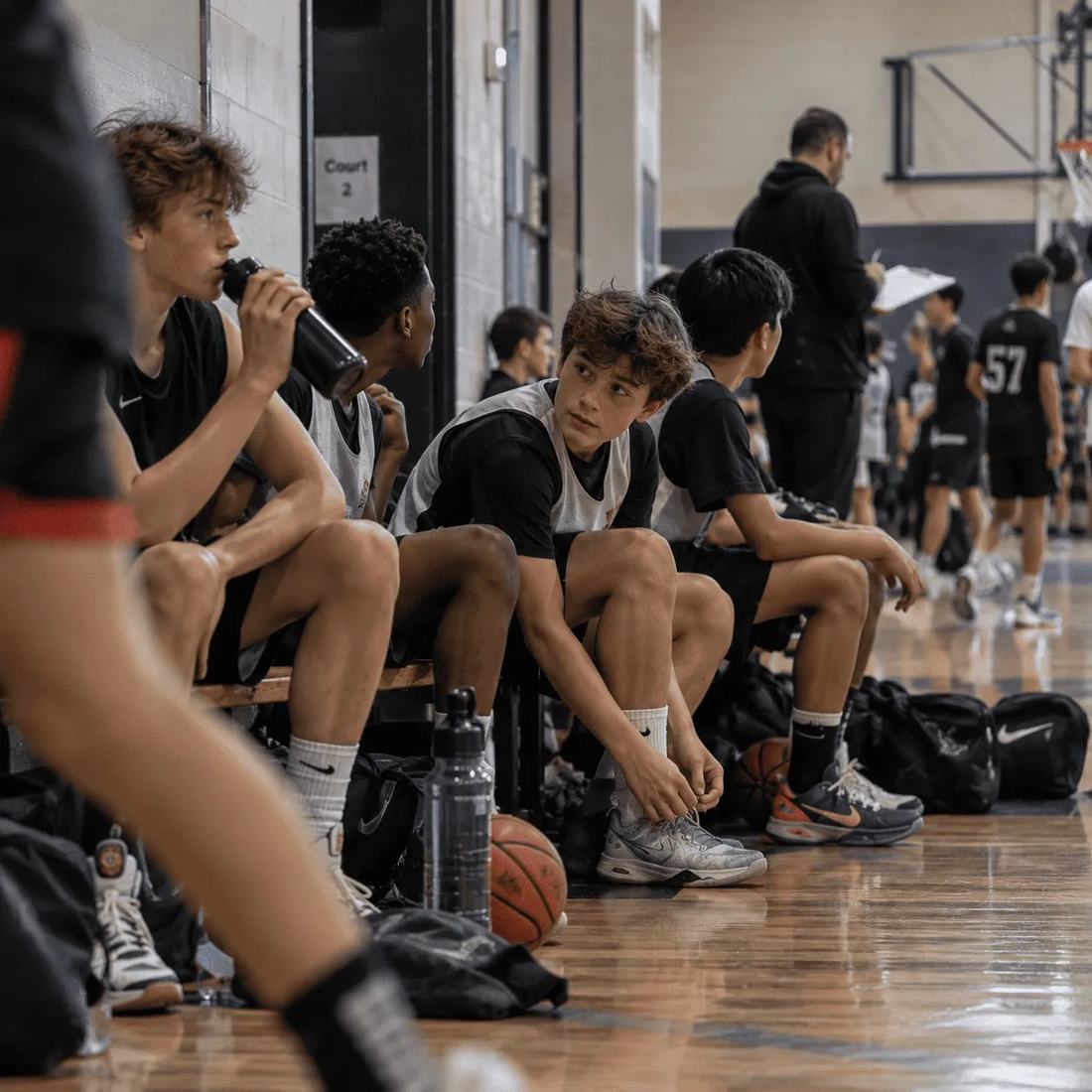 A youth basketball squad sitting together on the bench