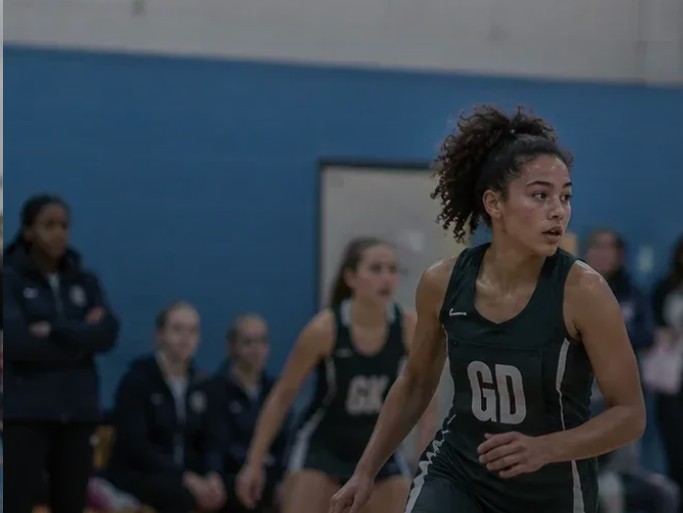 A young netball player focused during a game