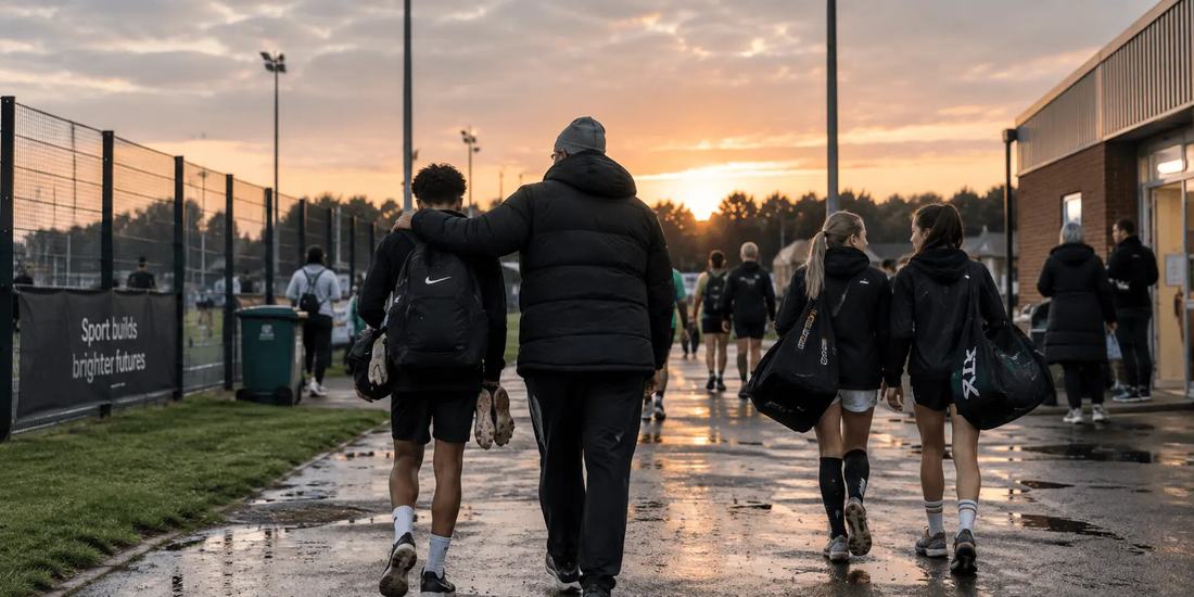 Young players and coaches walking into their club at sunset