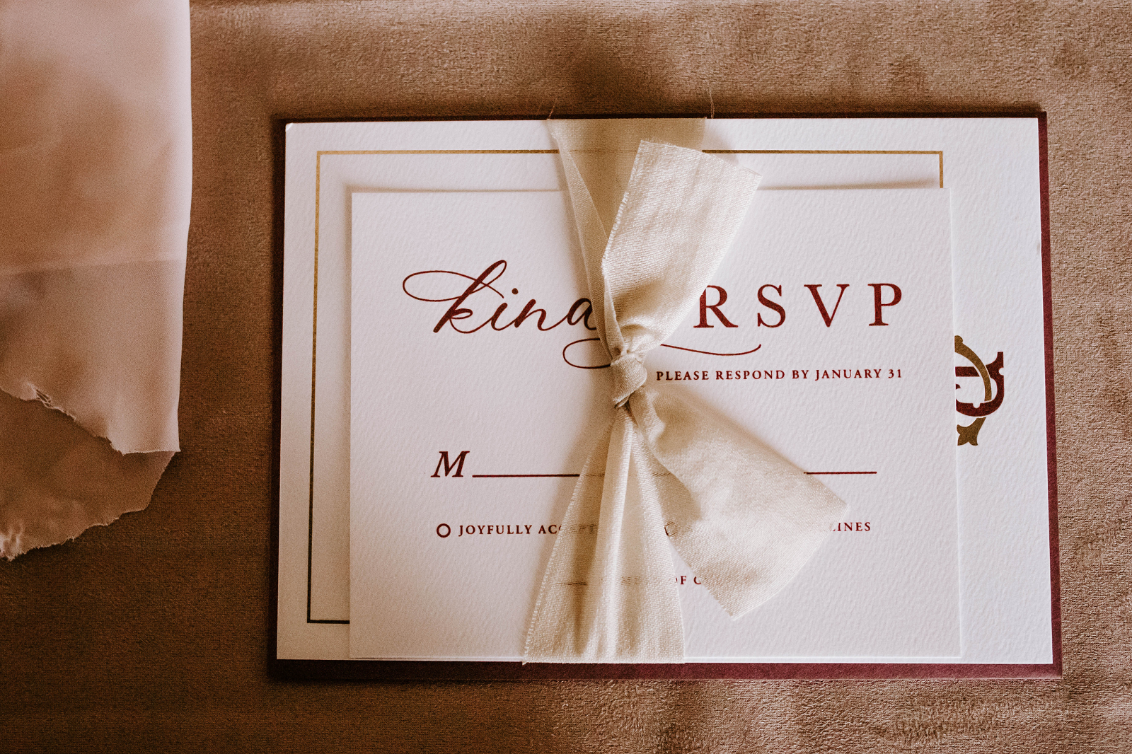 Wedding RSVP Card with Ribbon — Elegant cream RSVP response card tied with a soft ribbon, featuring formal wording and envelope, styled for a classic wedding invitation suite.