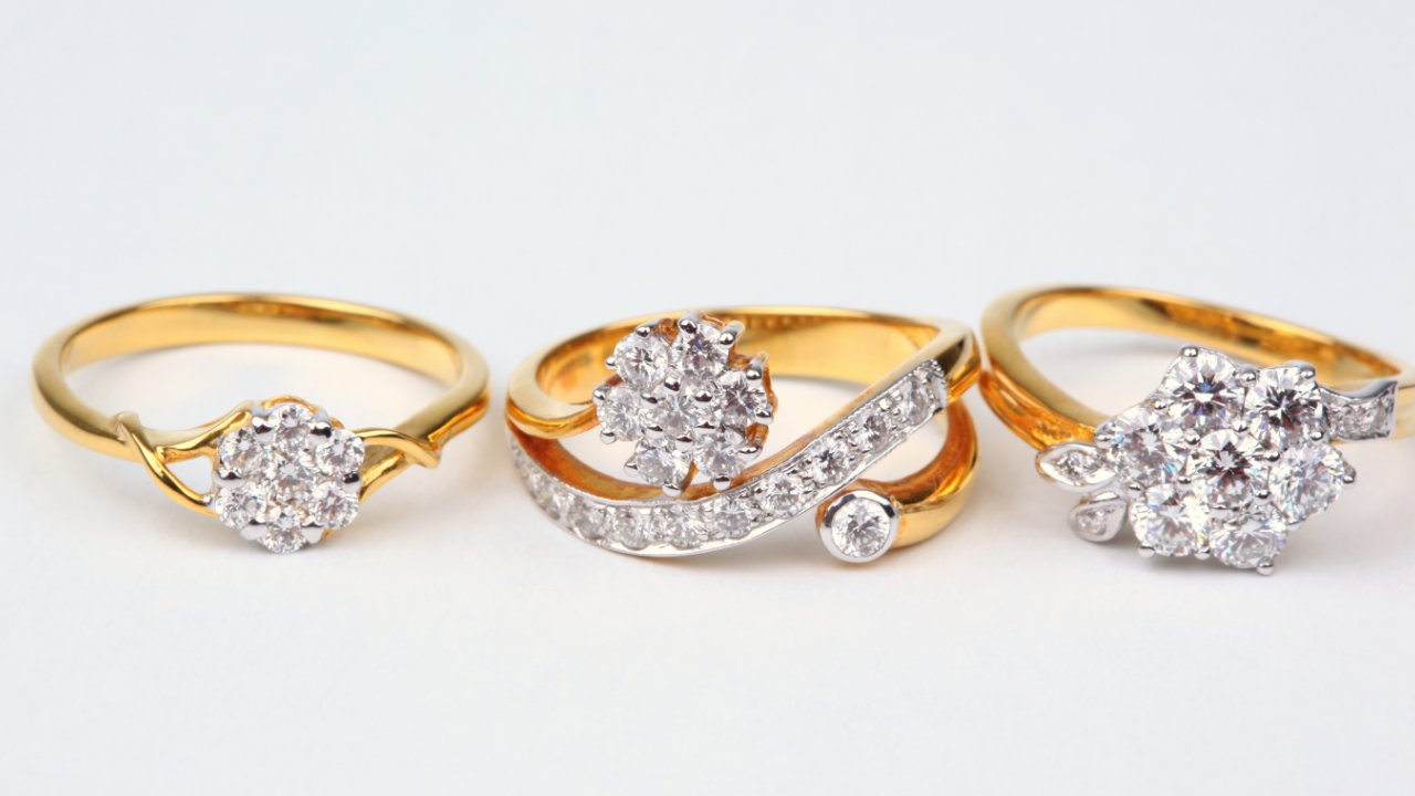 Elegant custom wedding ring designs featuring yellow gold bands with sparkling diamond cluster settings, showcasing three unique engagement ring styles for brides seeking inspiration for a personalized wedding ring or custom jewelry design.