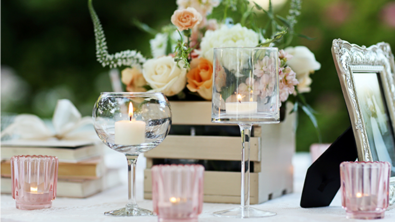 Elegant outdoor wedding reception table featuring blush and ivory floral centerpieces, floating candles, romantic décor, and timeless wedding styling for an LDS wedding celebration.