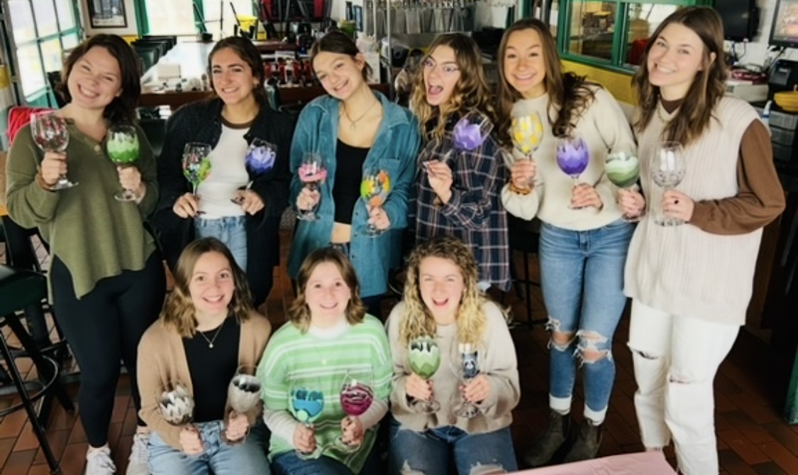 Bridal shower paint party guests in Cleveland with finished canvases