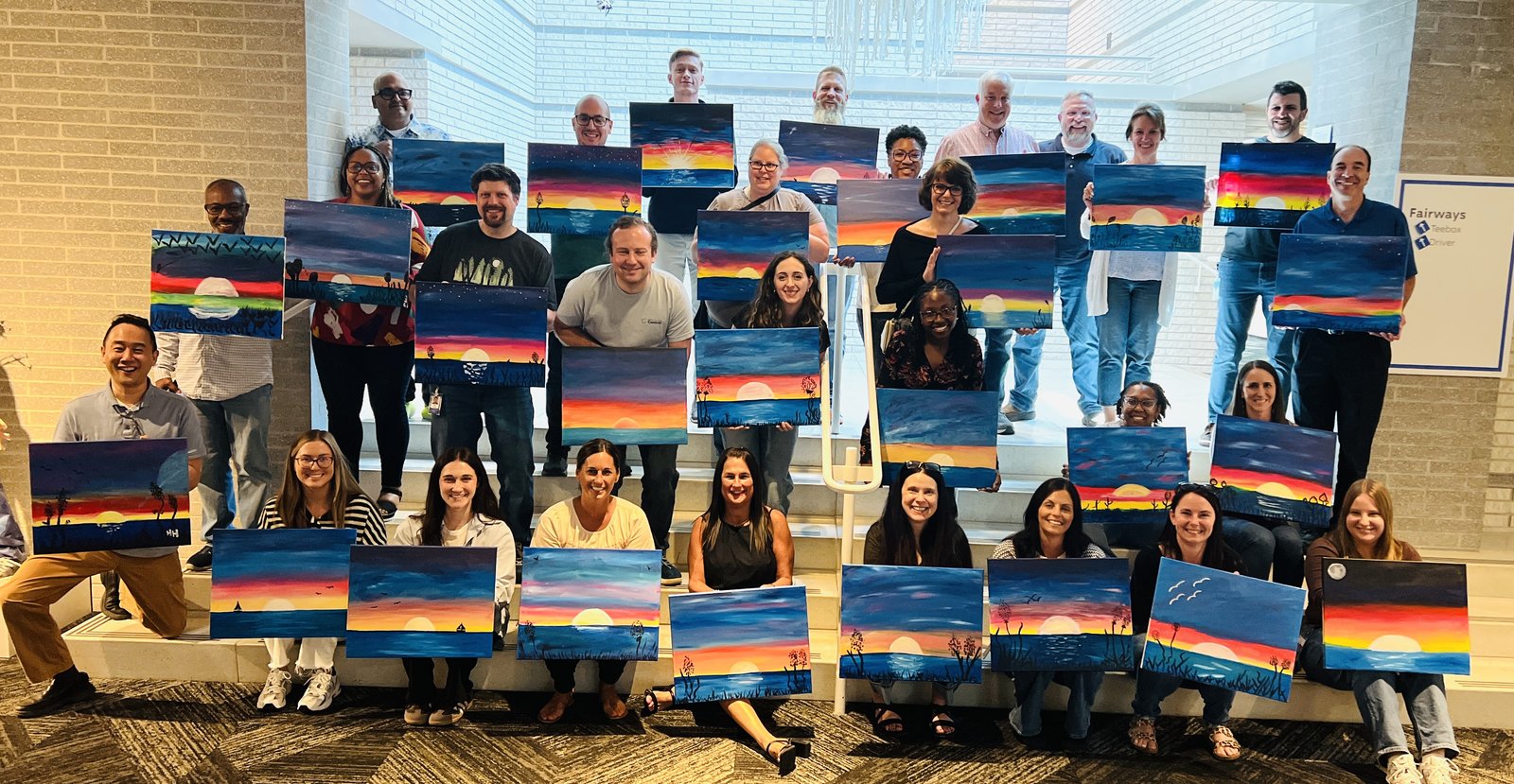 Adults enjoying a public paint and sip event in Cleveland