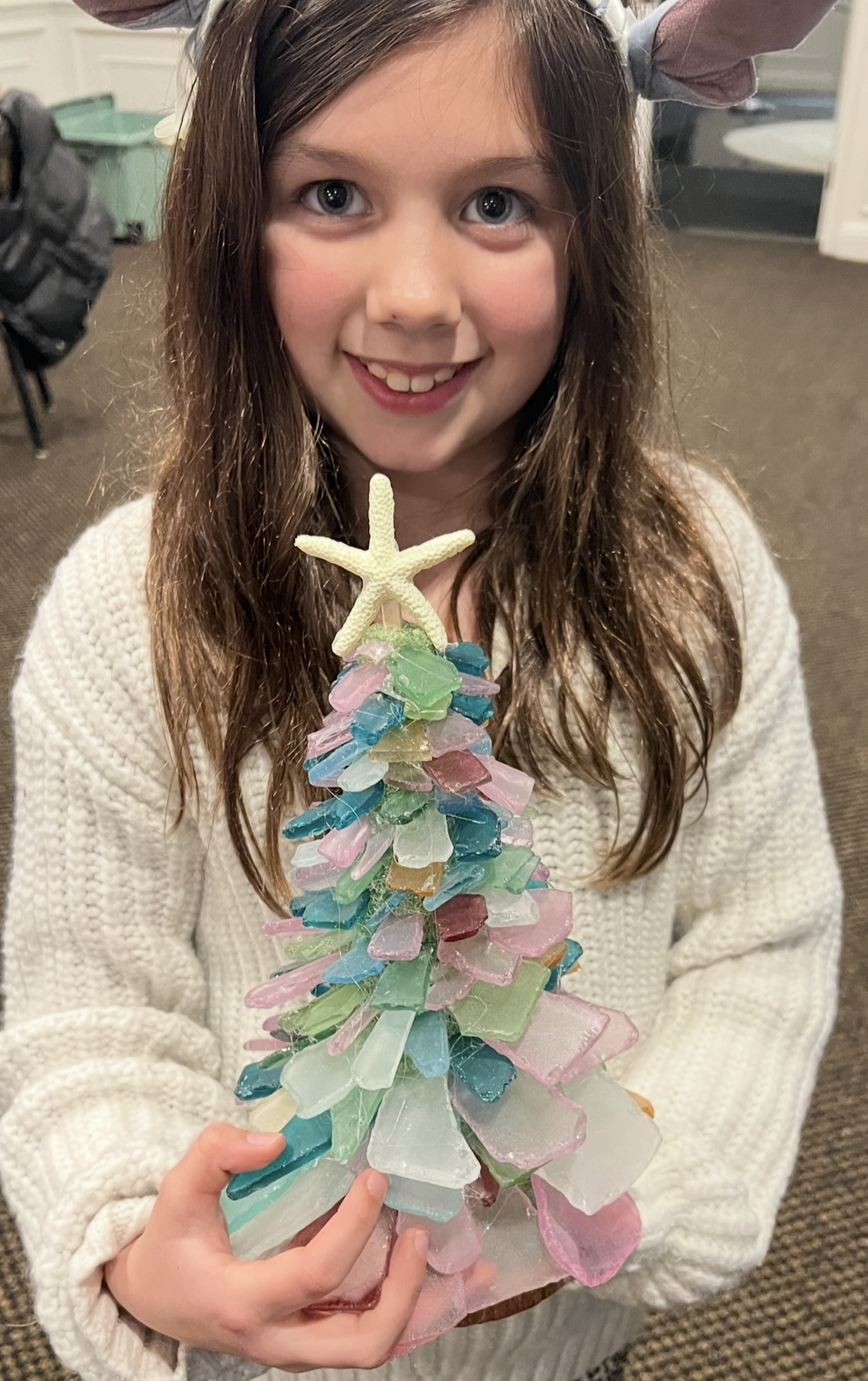 Child holding a sea glass tree at a kids party in Cleveland