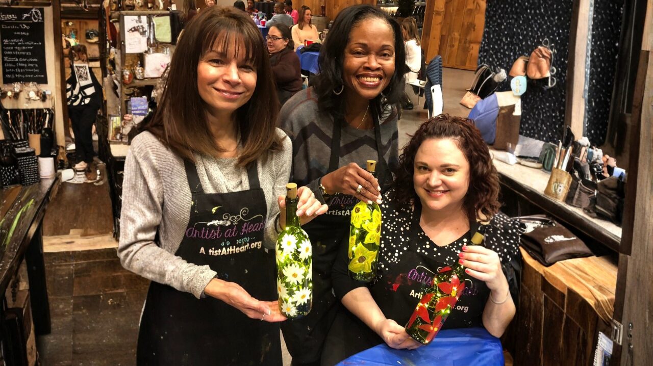 Wine bottle painting activity with cork lights at Artist at Heart in Cleveland