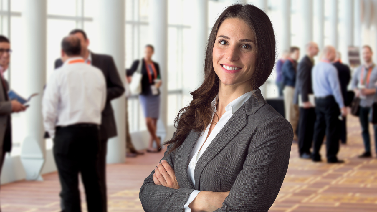 A female Freelance Event Manager standing in front of a group of people at a convention centre