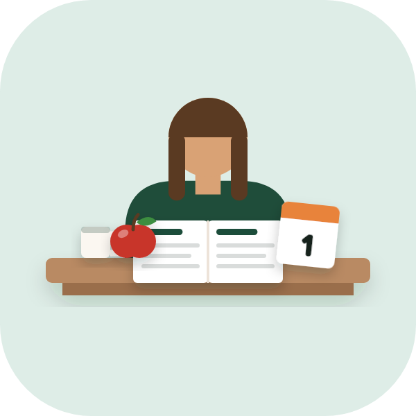 A teacher at a desk with an open lesson plan