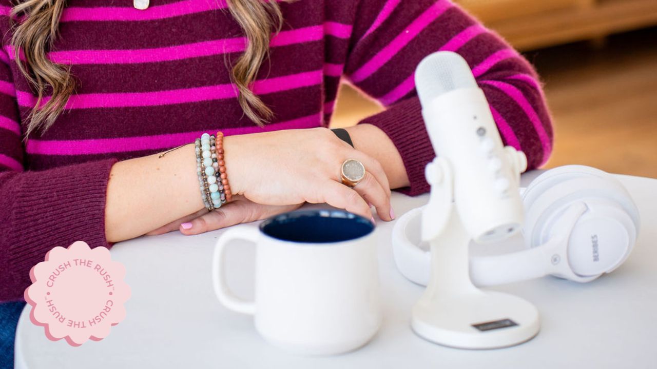 business strategist for female entrepreneurs Holly Haynes with podcast microphone, headphones, and coffee mug