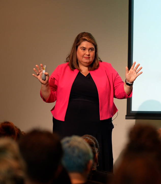 Meredith Wilson delivering a workplace culture keynote to senior leaders