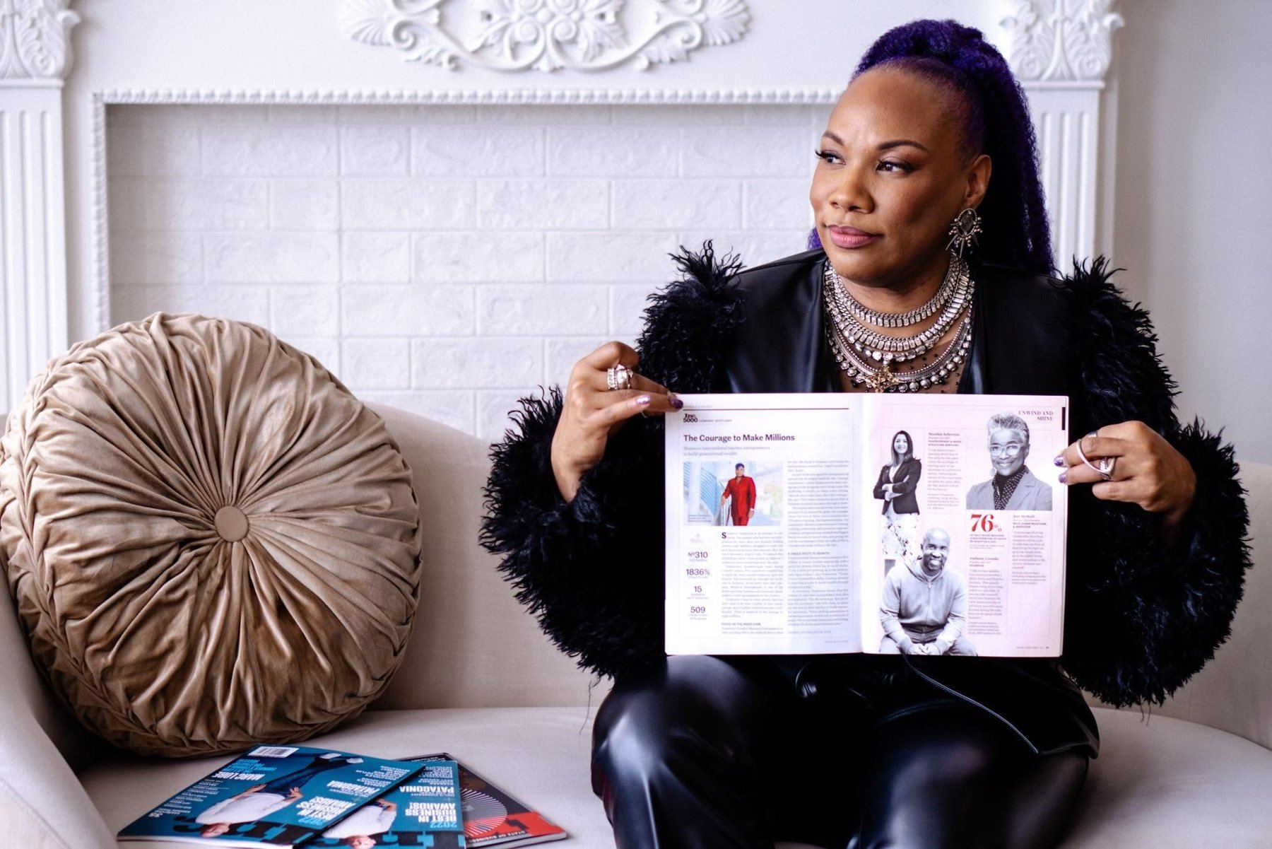 Shameca Tankerson holding open her Inc. 5000 Company Spotlight feature
