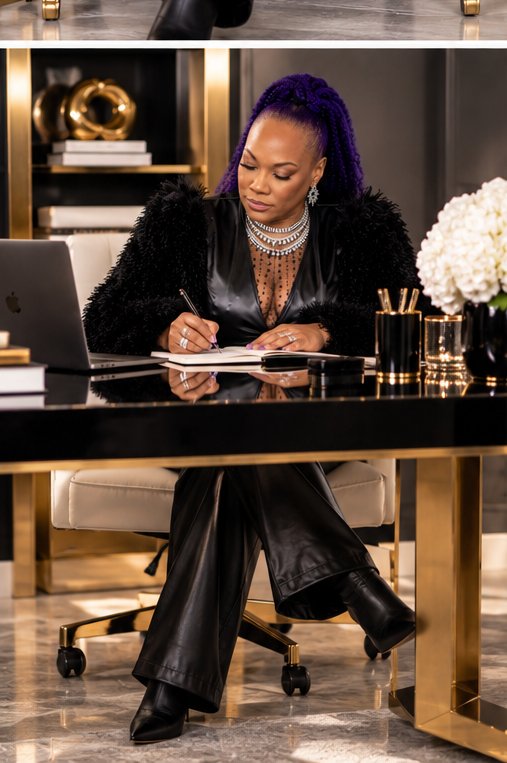 Shameca writing at a black and gold desk