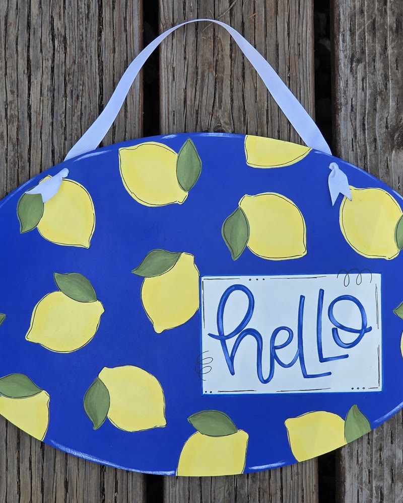 Hand lettered 'hello' oval door hanger with lemons, made by a student