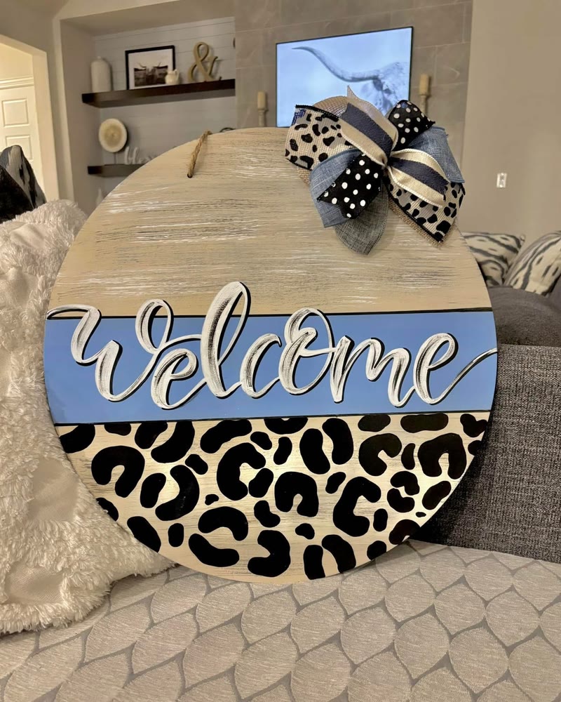 Hand lettered 'Welcome' round door hanger with leopard print, made by a student