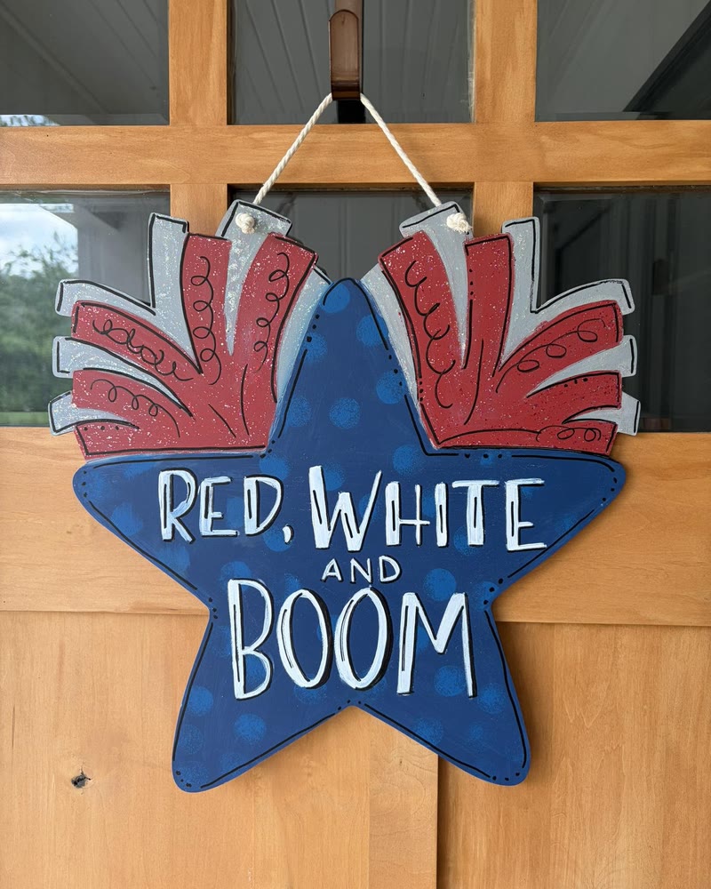 Hand lettered 'Red, White and Boom' star door hanger, made by a student