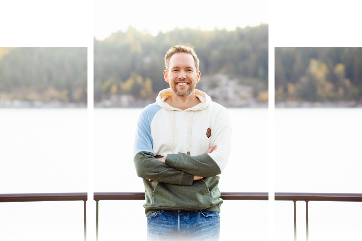 JD standing in front of a lake in a nice hoodie