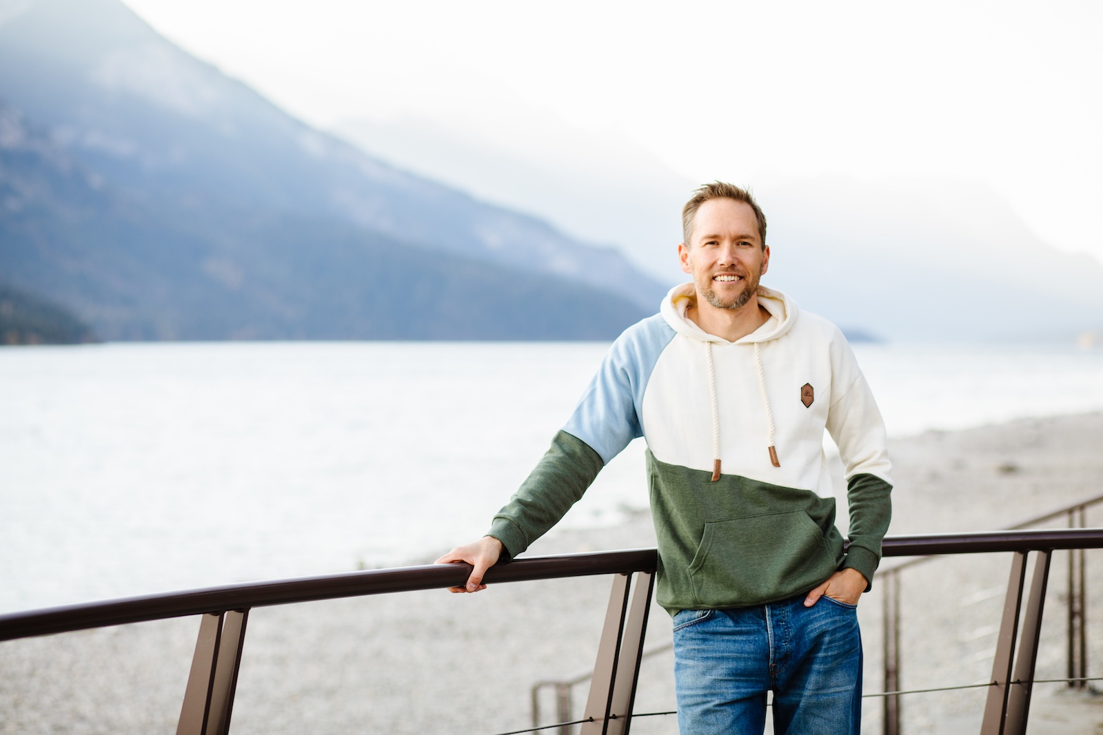 JD in a nice hoodie standing in front of a lake