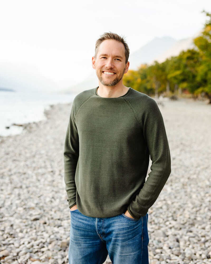 picture of JD in jeans and a green sweater