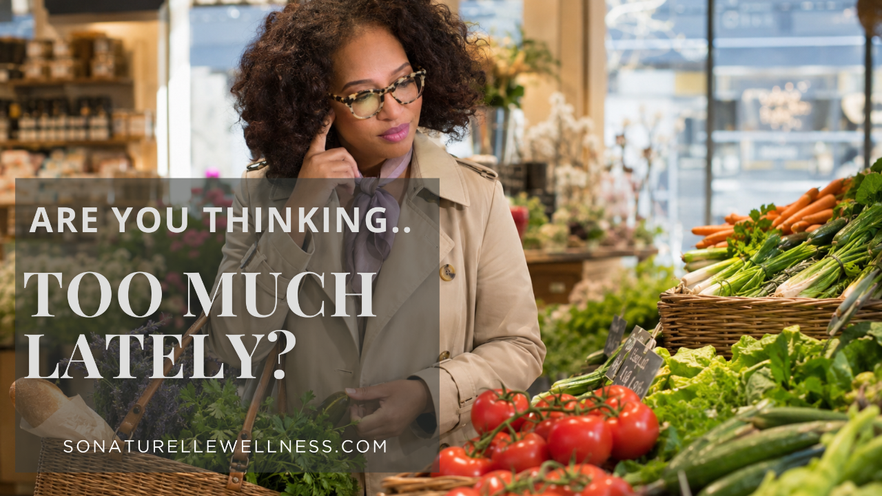 Midlife woman standing in the produce section of a beautiful grocery store.