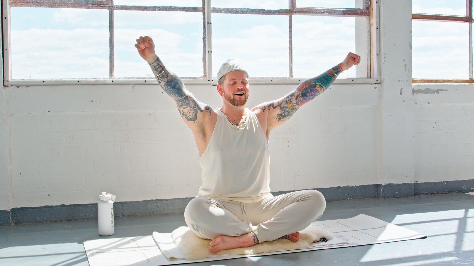 Kyle Gray performing some Kundalini exercises in a sunlit room