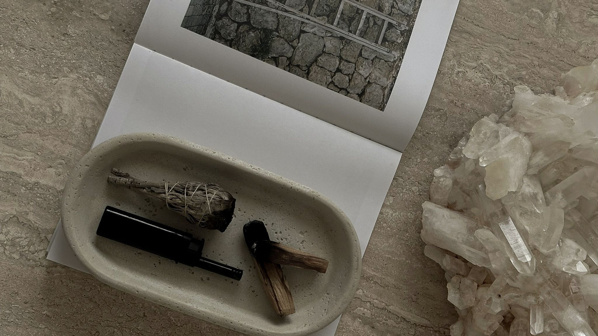 Artistic workspace with brushes, ink, and architectural reference materials